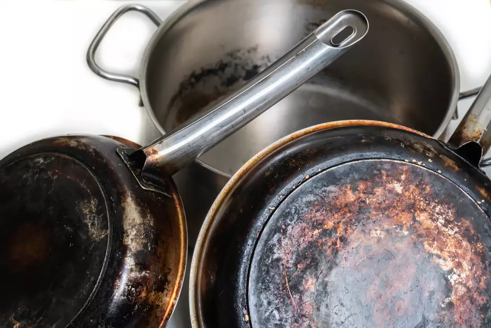 burnt and dirty stainless steel pots and pans