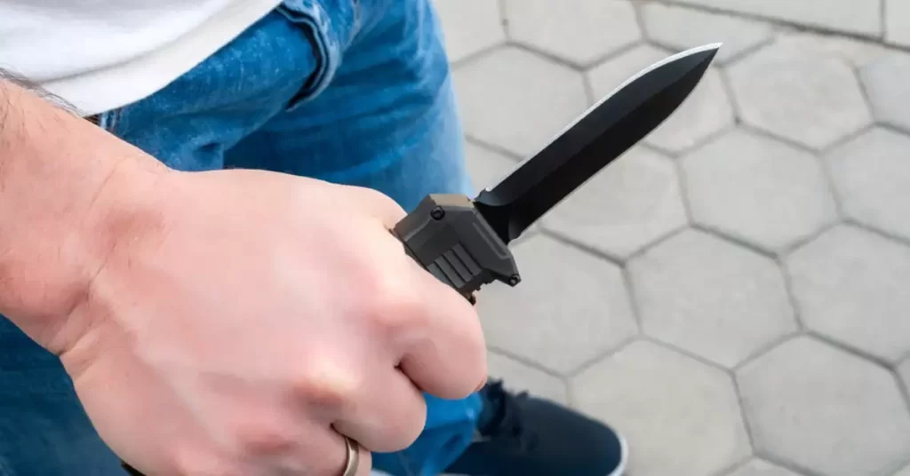 OTF knife in hand