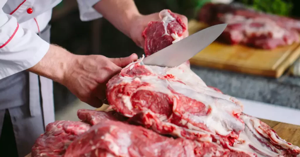 cutting meat with a kitchen knife